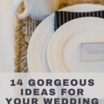 Formal place setting with white plates, black cloth napkins with a white pinstripe on a natural woven placemat