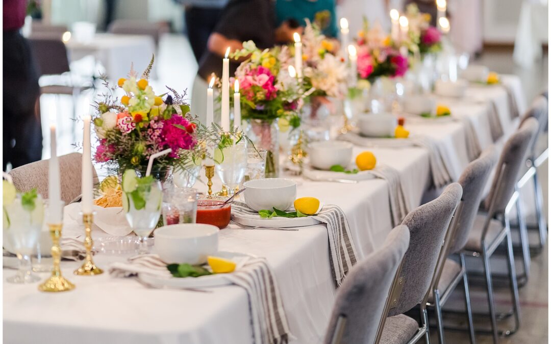 Beautiful colorful wedding reception tablescape with bright pink, purple and yellow flowers