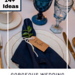 Formal place setting with a white plate, blue cloth napkin and blue goblet